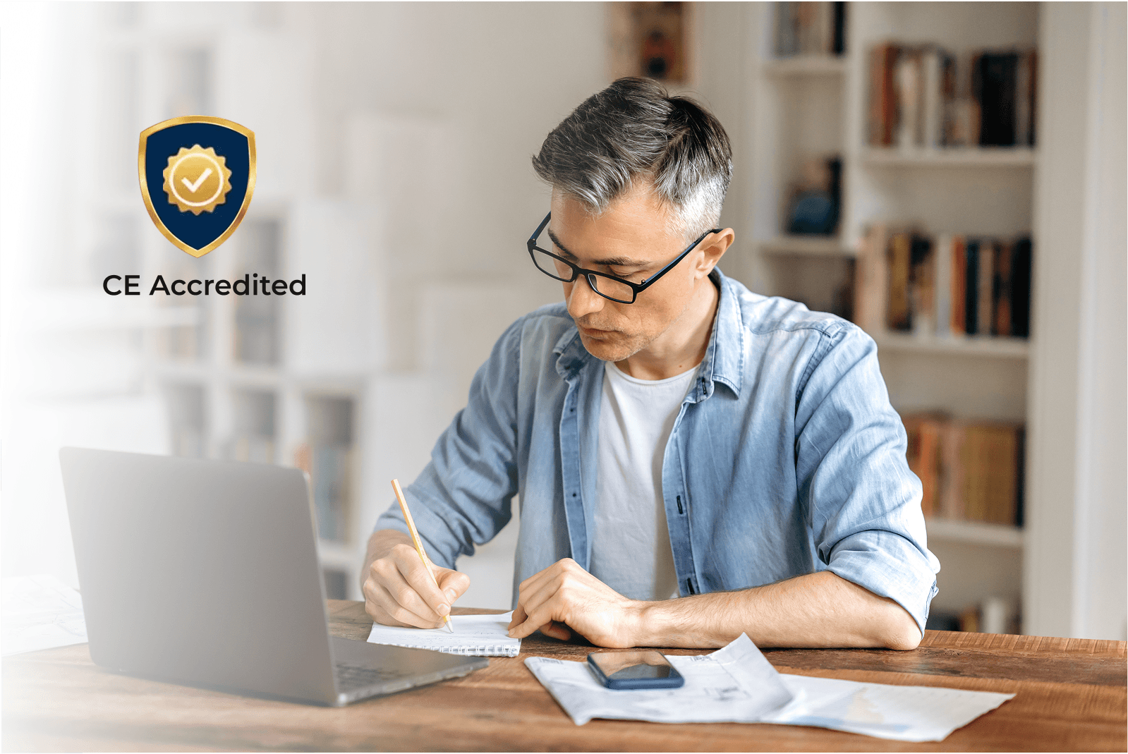 Man at a computer with a CE Badge